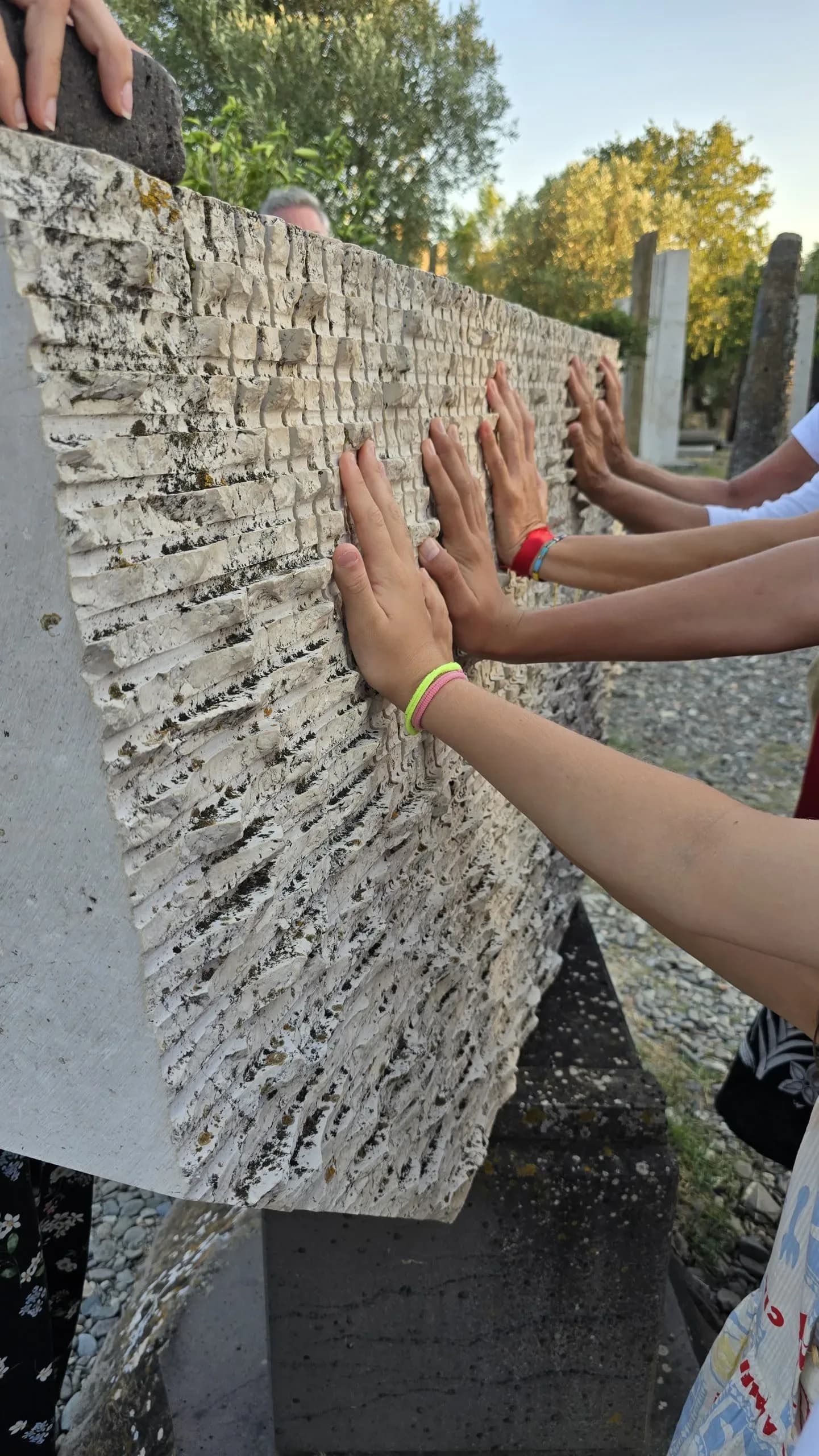 Visitors listening to stone vibrations at Giardino Sonoro