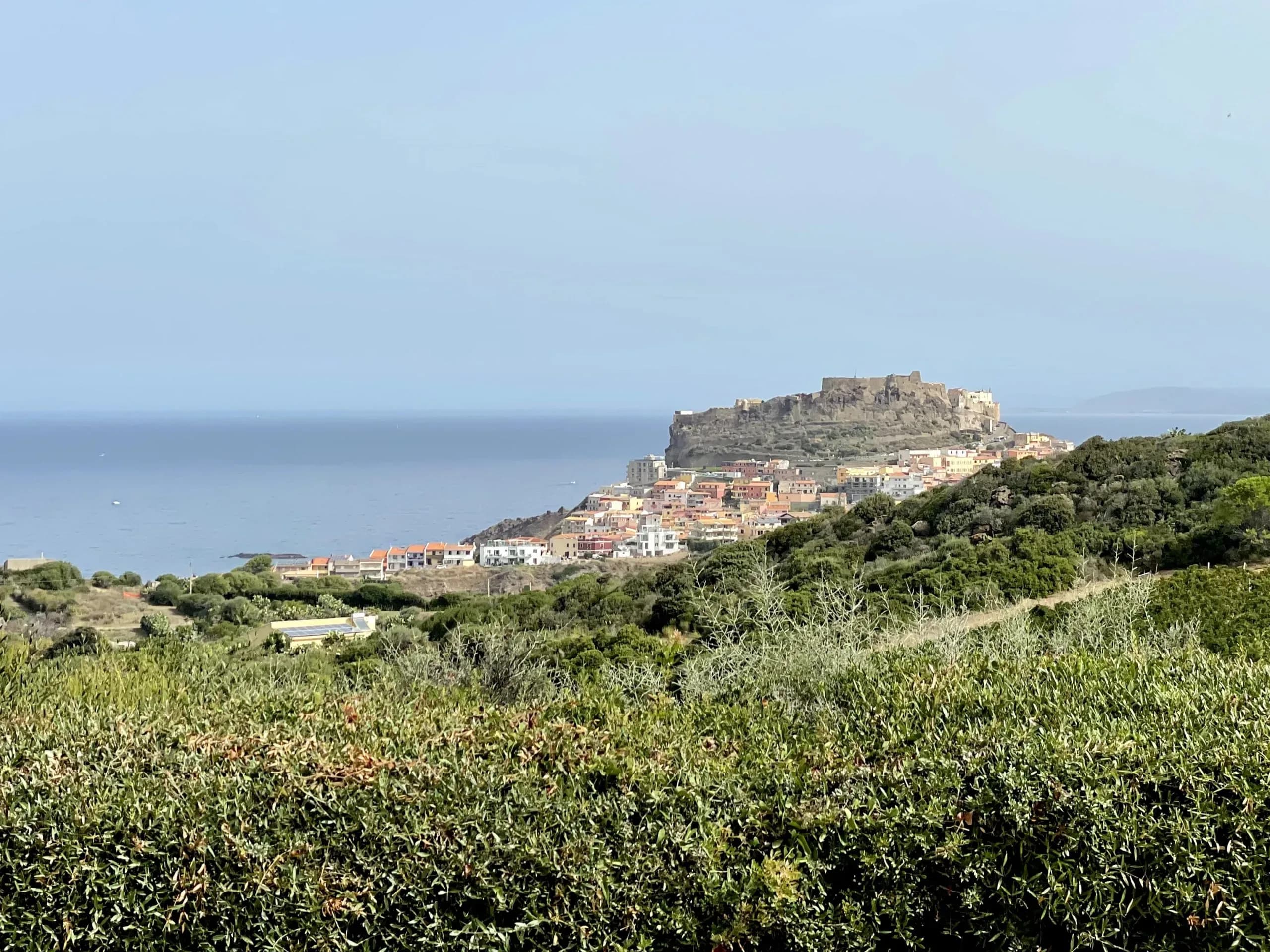 Bajaloglia Resort sea view suites private terraces infinity pool Gulf views Castelsardo fortress contemporary Mediterranean design whitewashed walls gardens