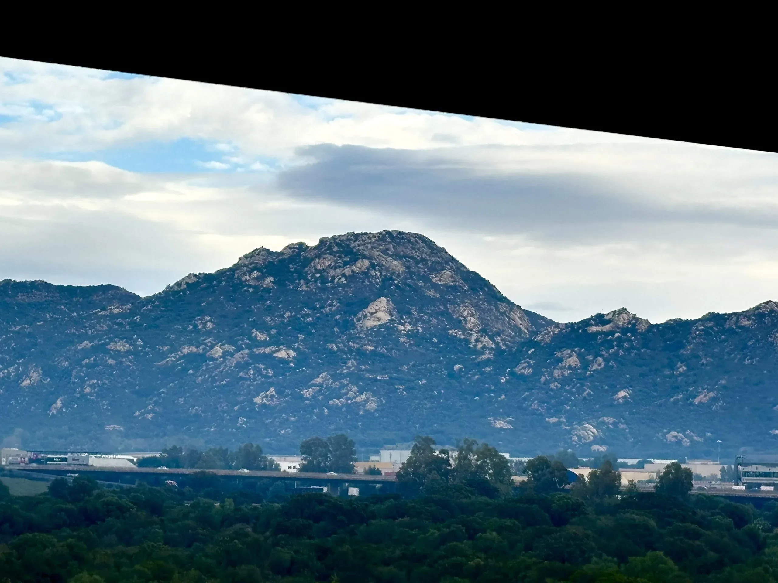 Mountain landscape with cloudy sky and greenery