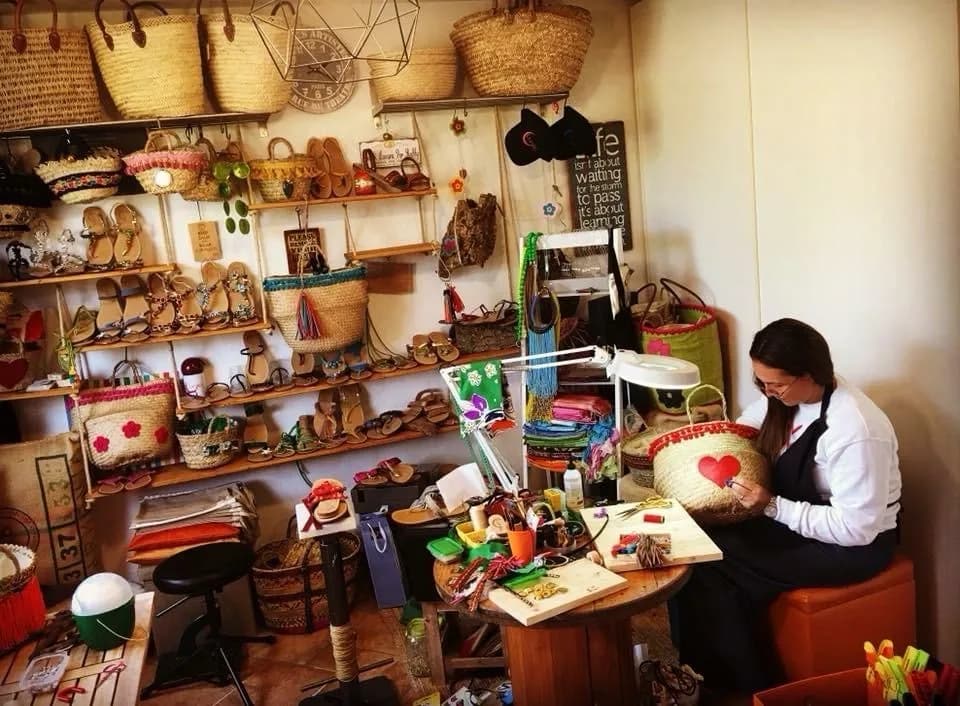 Artisan crafting handmade wicker bags in a workshop