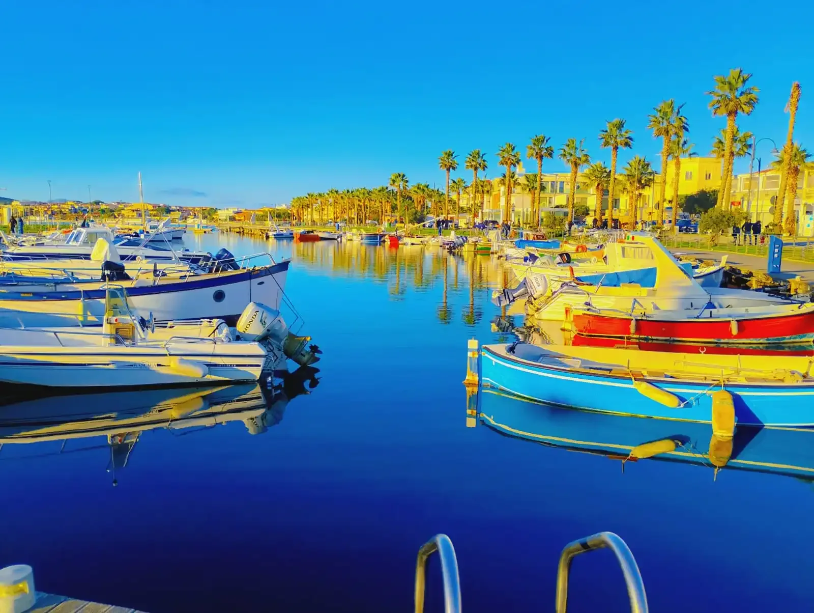 Colorful boats docked in sunny harbor