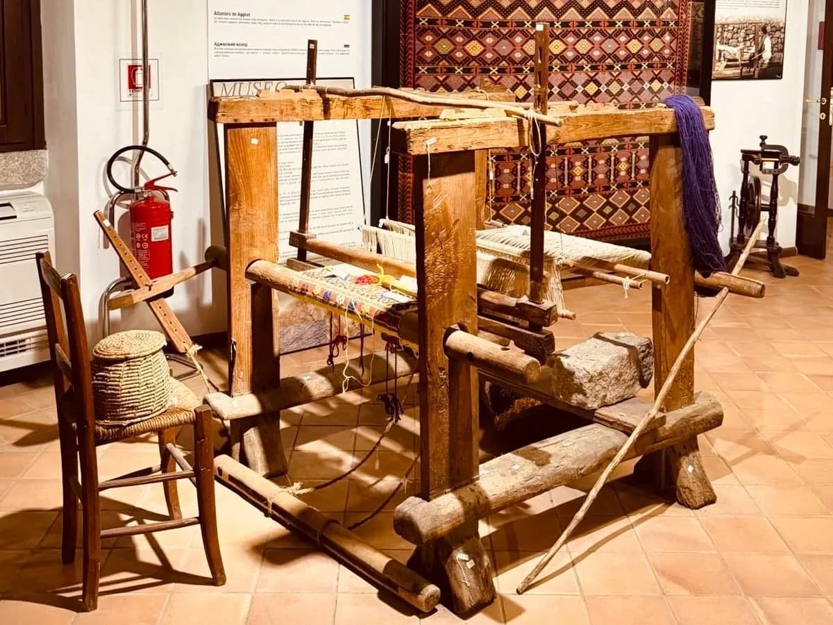 Traditional wooden loom displayed in a museum.