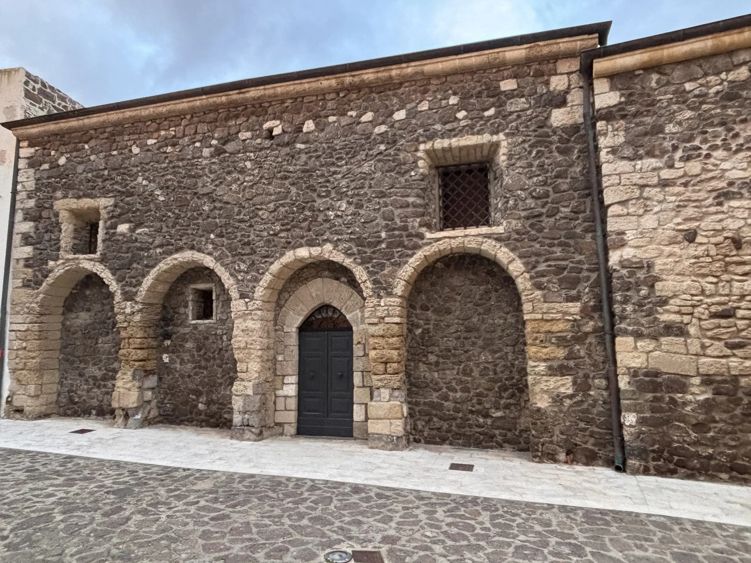 Stone building facade with arches and windows
