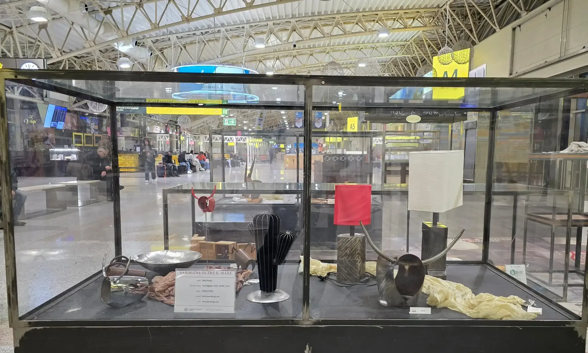 Vitrine im Flughafen mit Kunst- und Designobjekten.