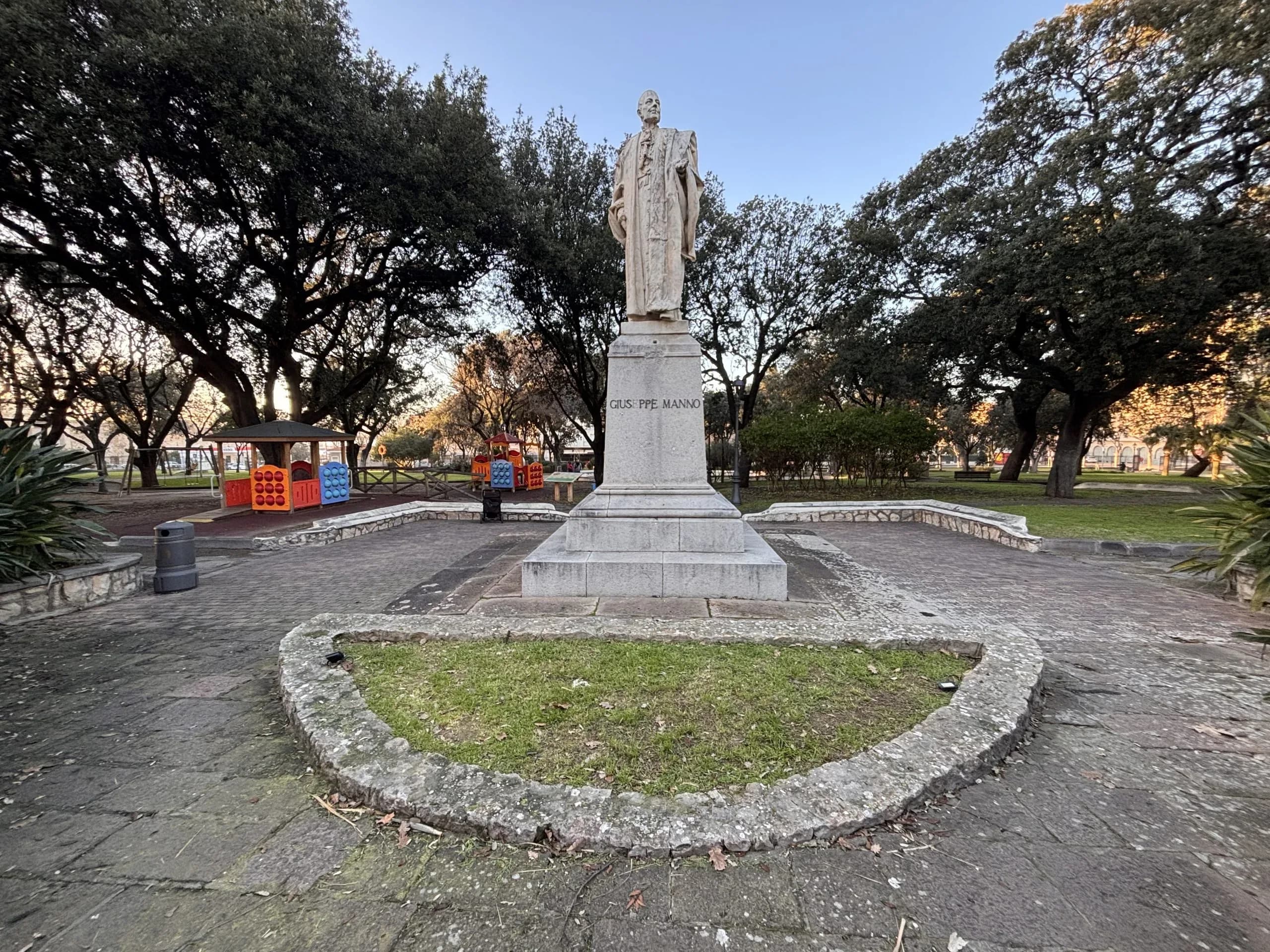 Giuseppe Manno statue in park, with playground.