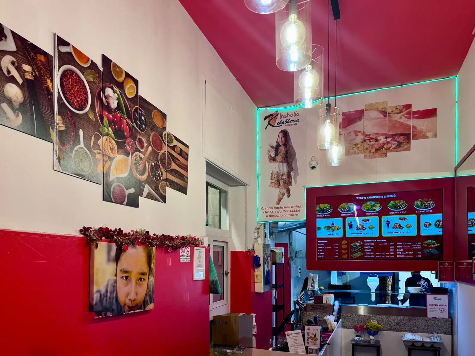 Inside view of Inshalla Kebabberia, colorful decor, food menu