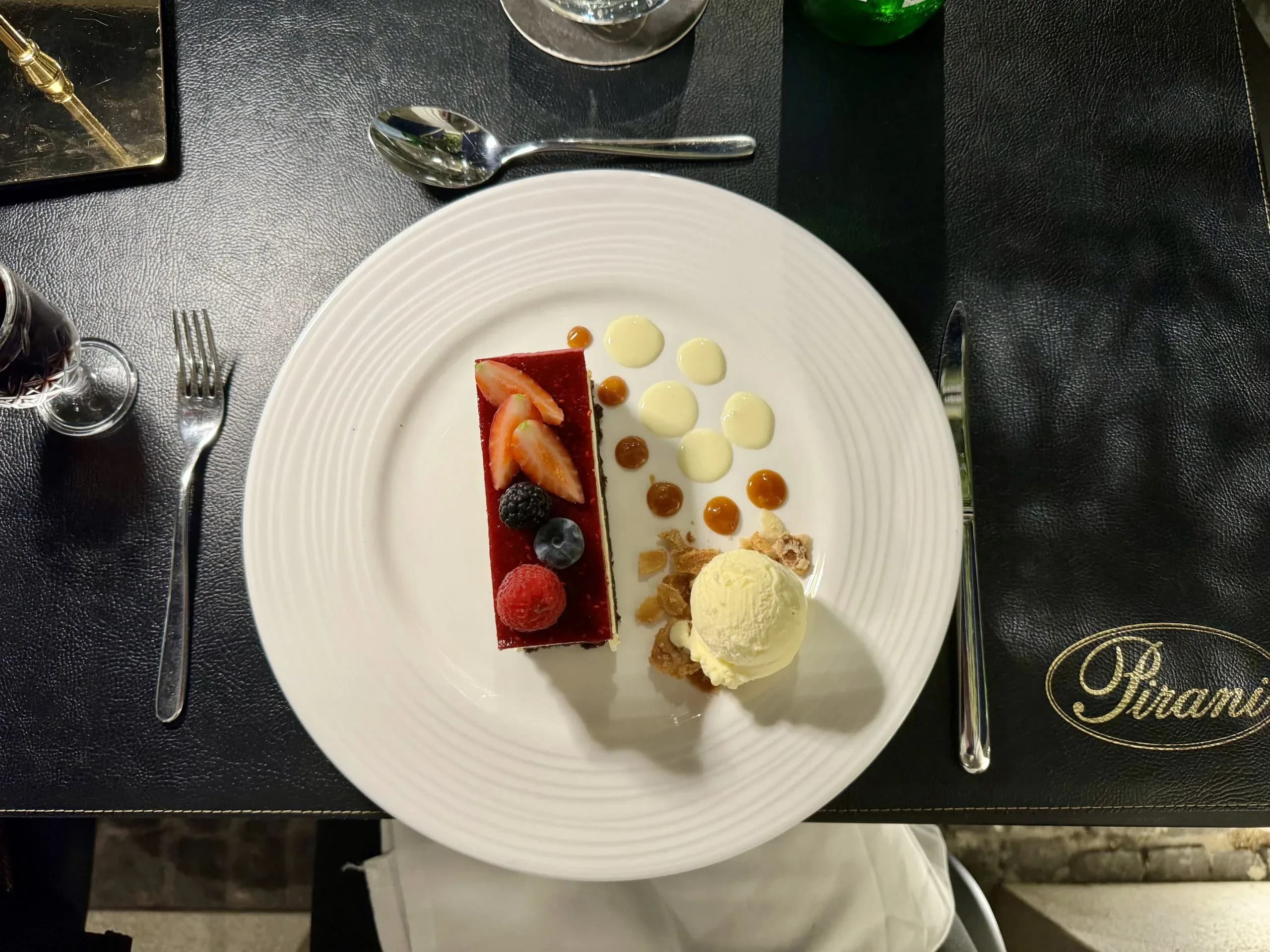 Elegant dessert with berries and ice cream.