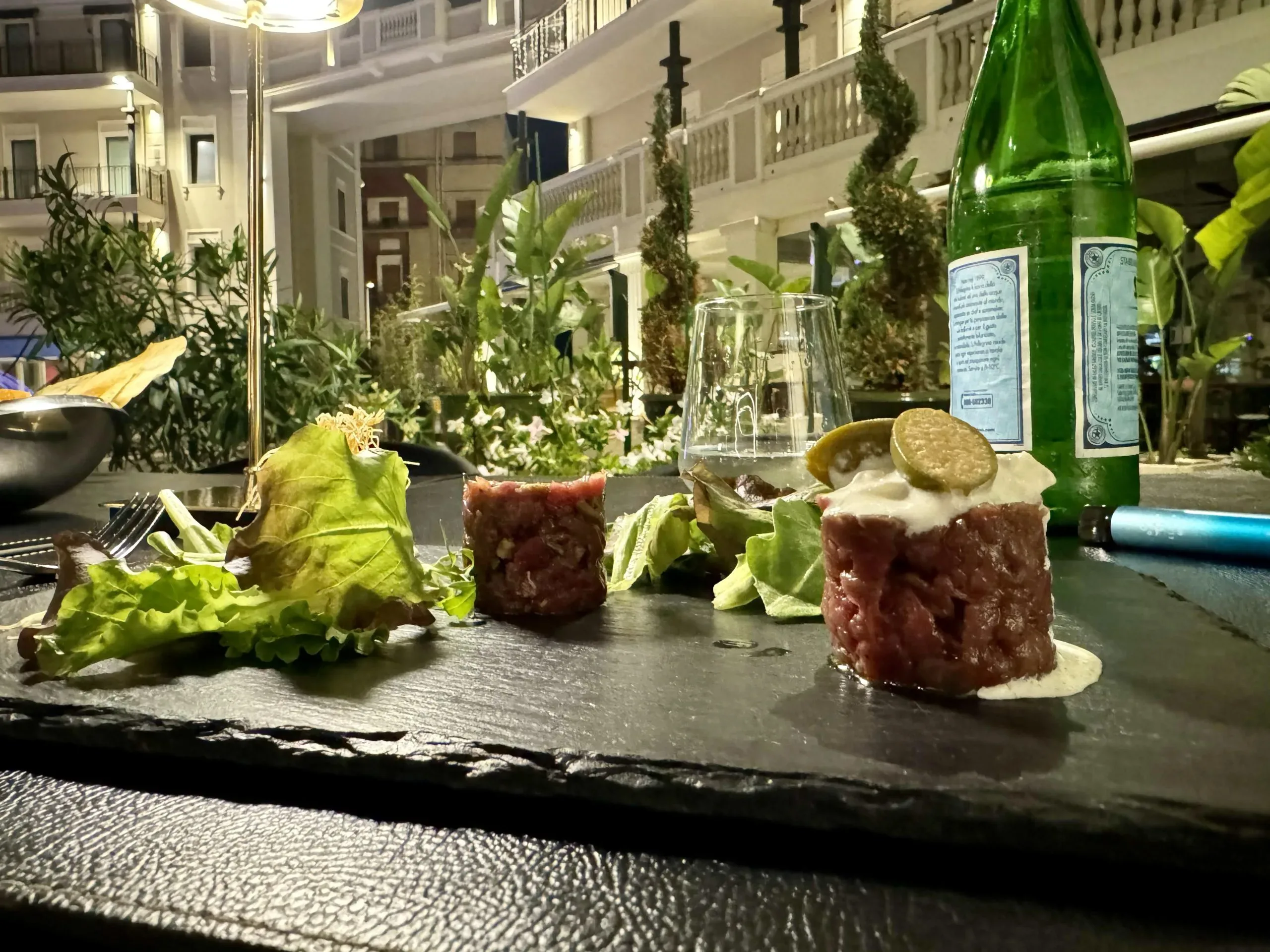 Beef tartare appetizer at an outdoor restaurant.