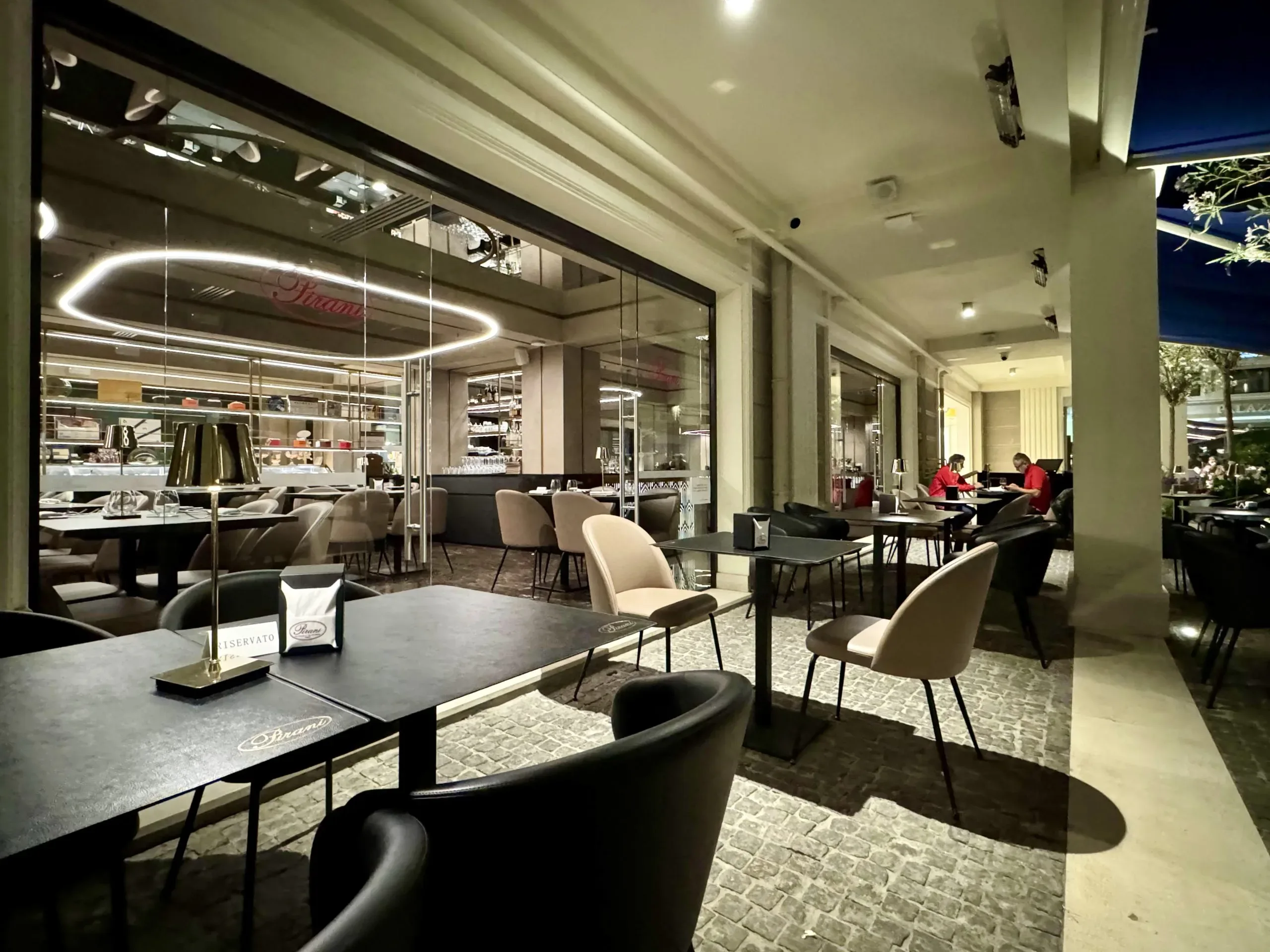 Outdoor restaurant seating with tables and chairs.