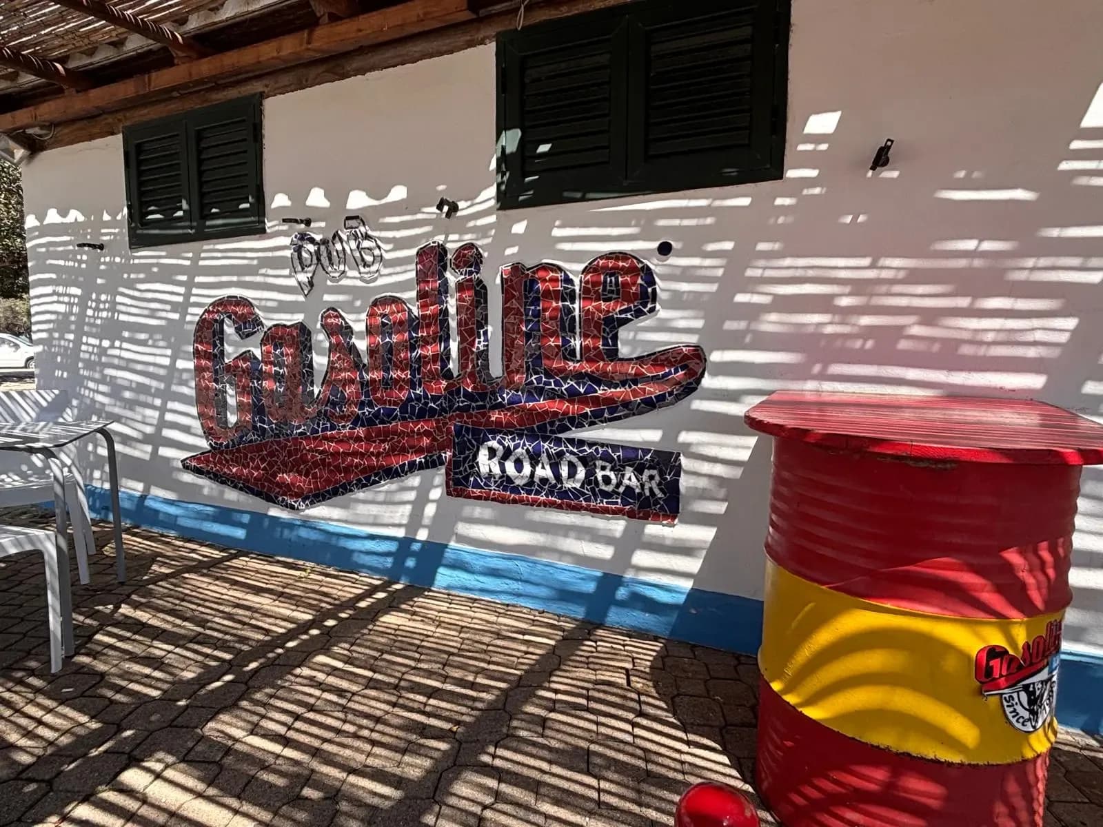 Gasoline Road Bar outdoor sign and repurposed barrel table.