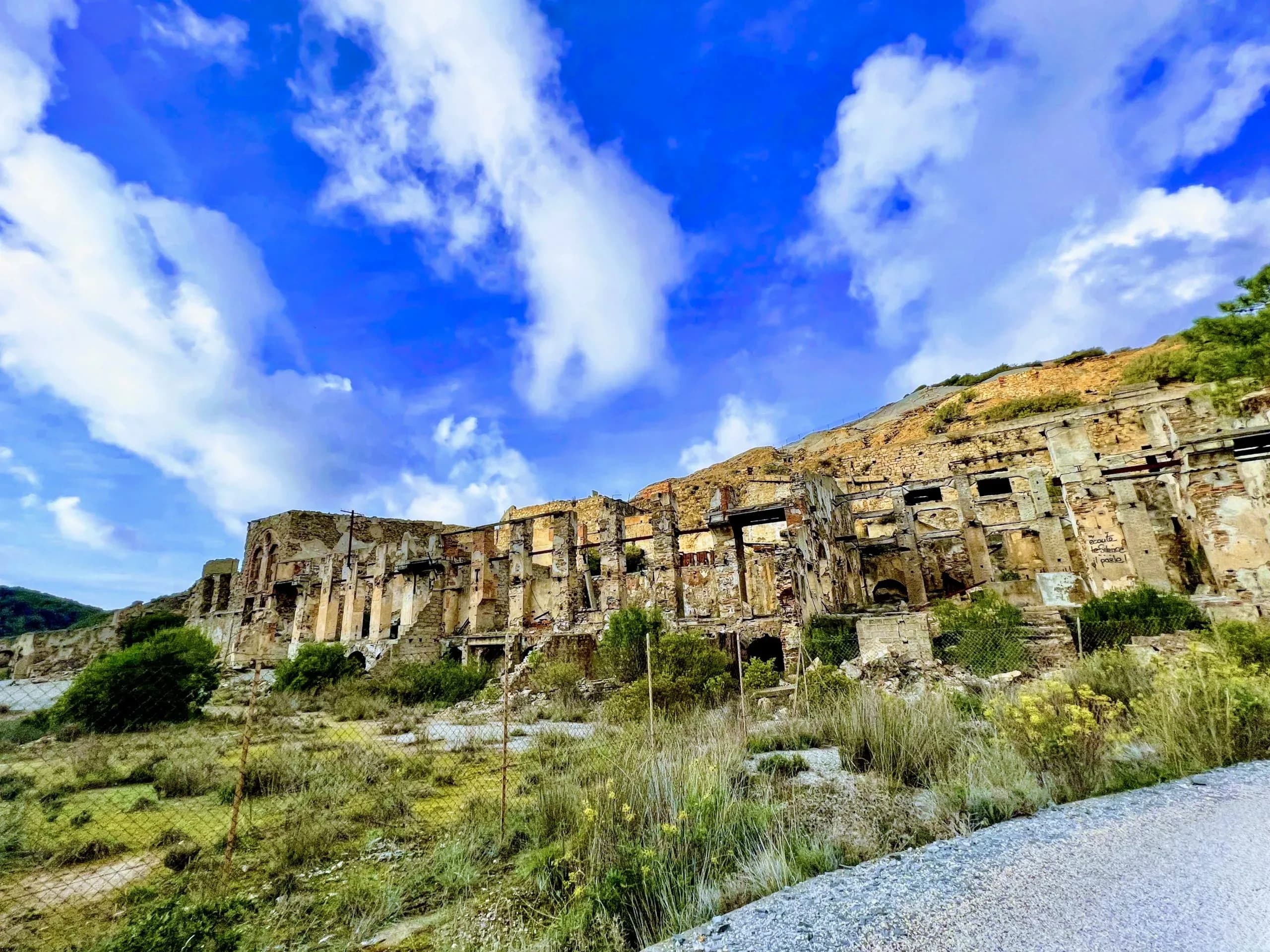 Ruins of a building against a bright sky.
