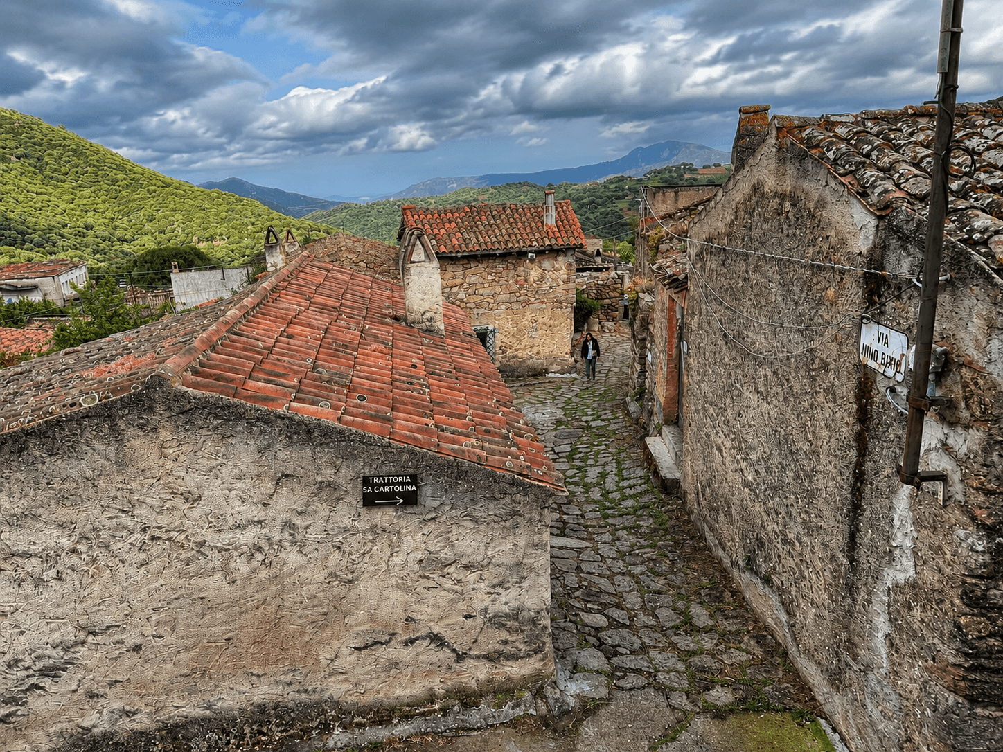 Village de pierre rustique avec ruelle pavée et collines