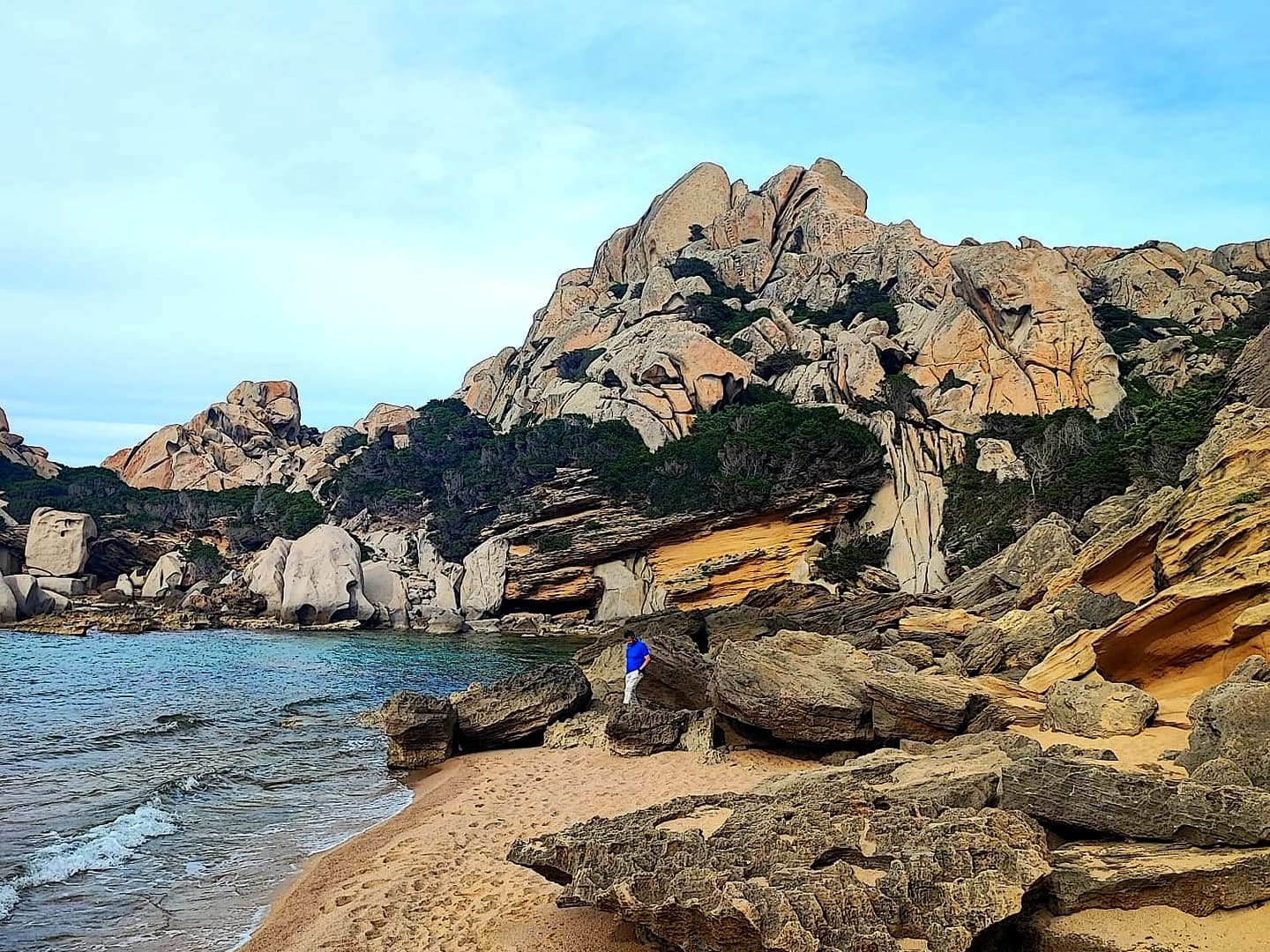 Rocky coastal cliffs and sandy beach shoreline