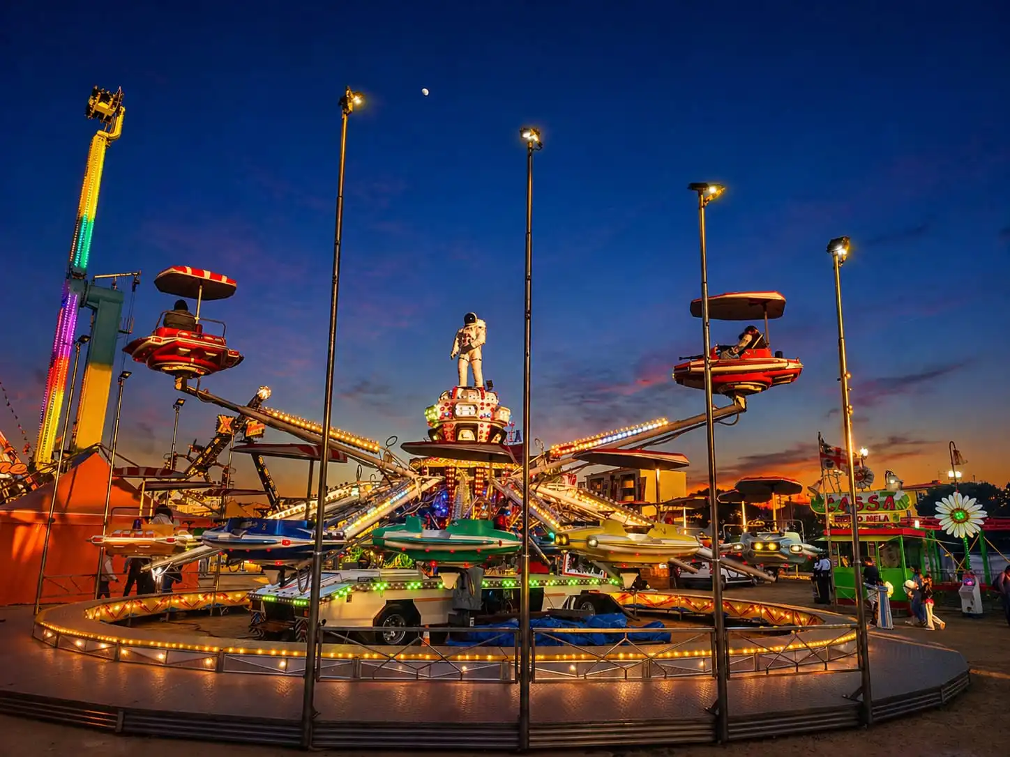 Colorful carnival ride at sunset with bright lights