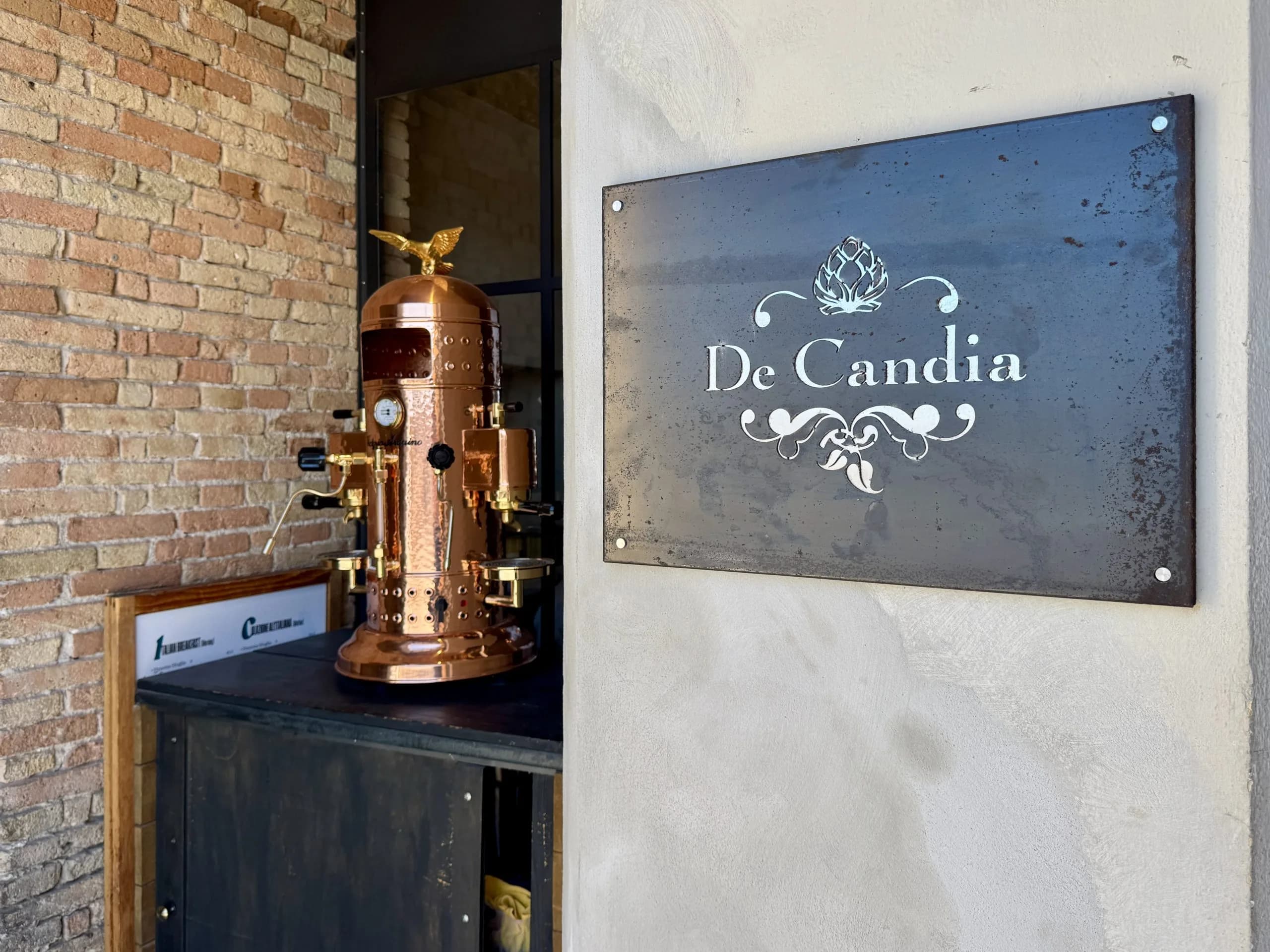 De Candia sign beside copper espresso machine