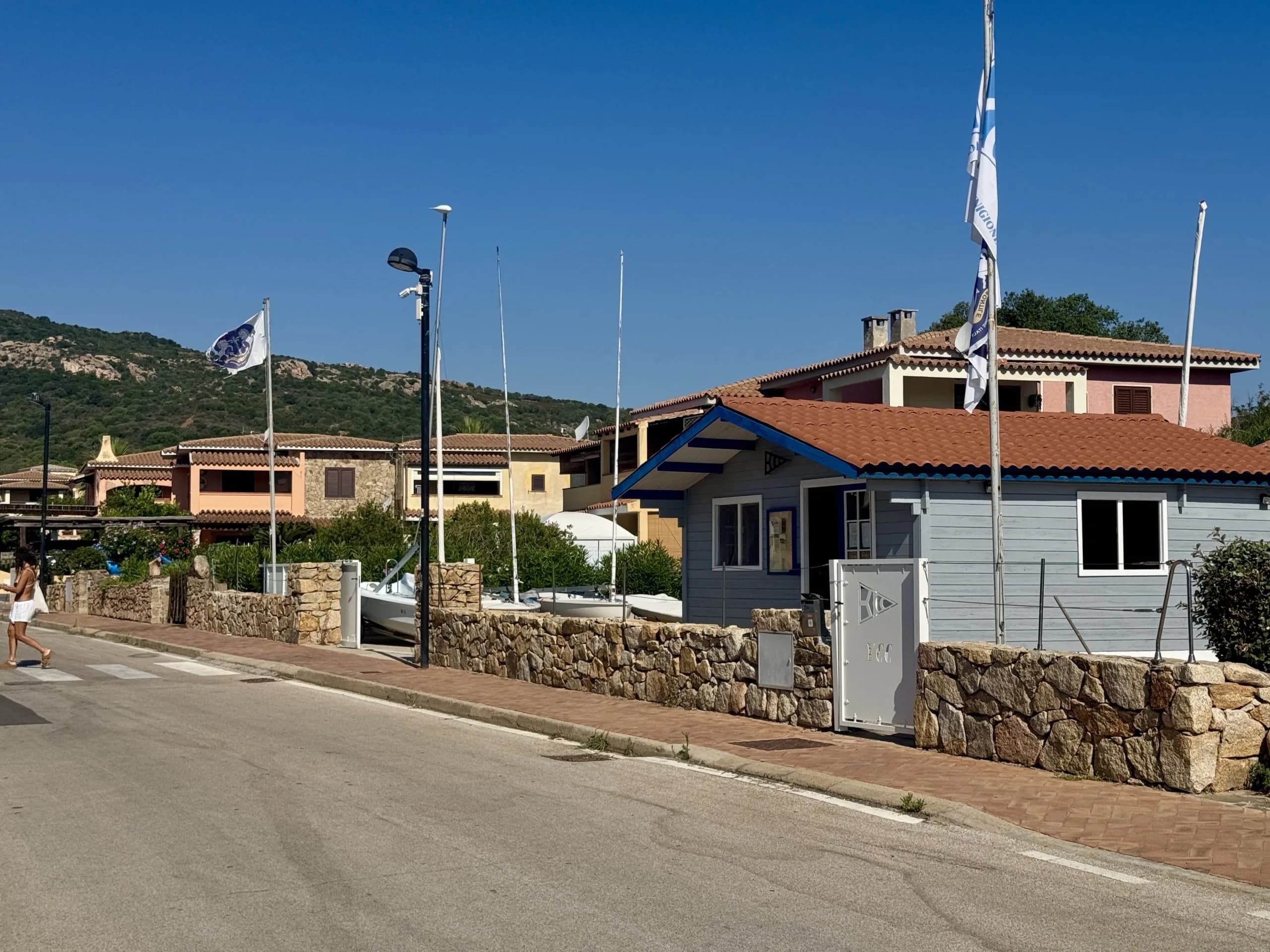 Sunny coastal village with pastel houses and flags