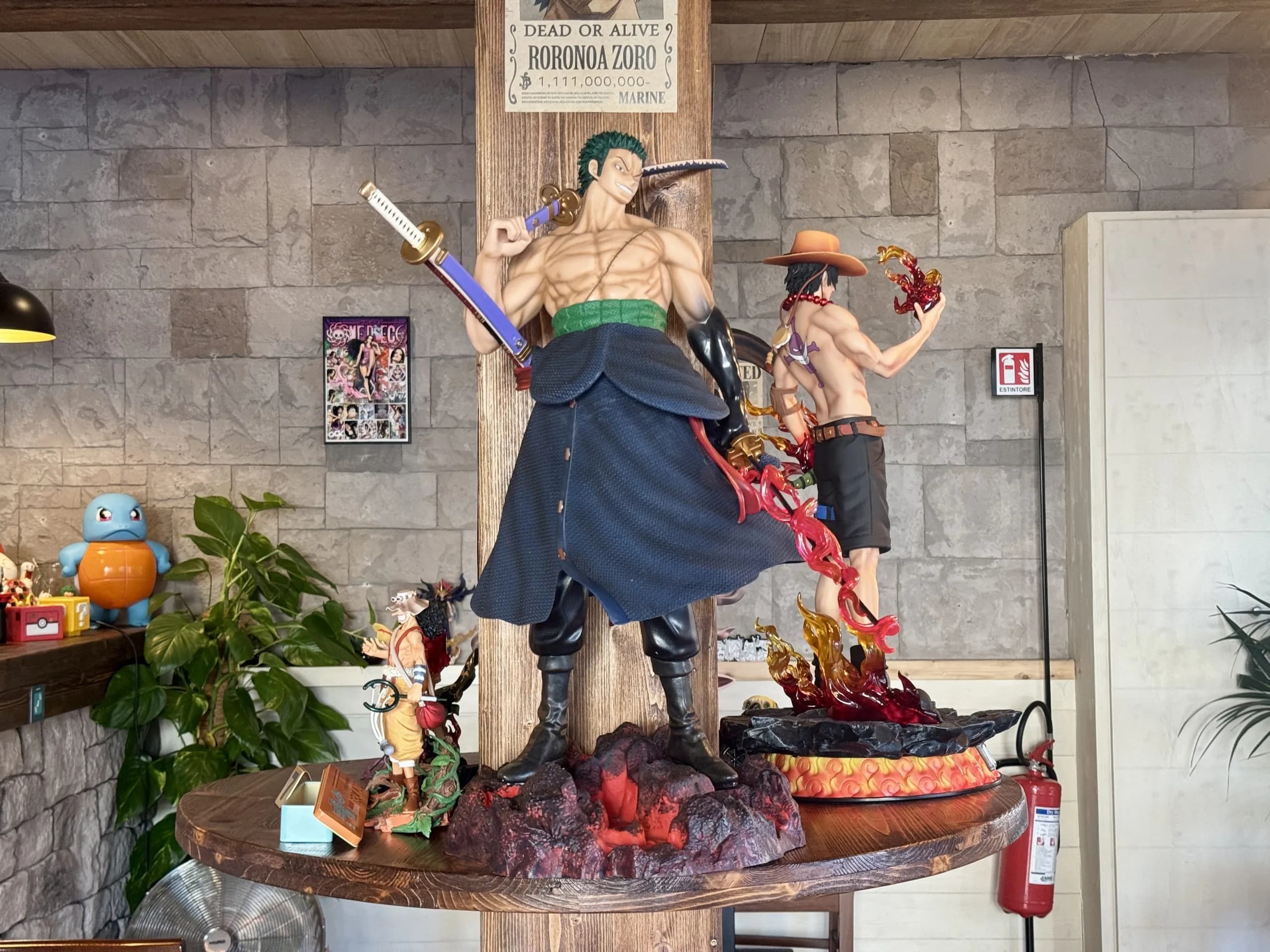 Large One Piece character statues on display table