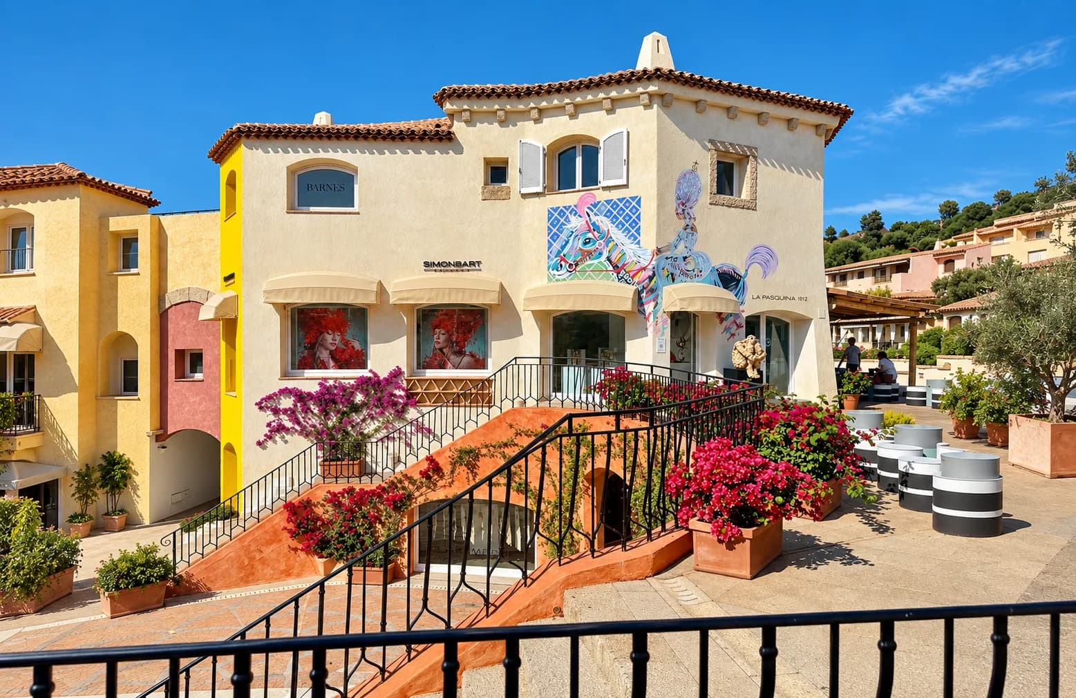 SimonBart Gallery building in Porto Cervo with a horse mural, bougainvillea planters and an outdoor staircase