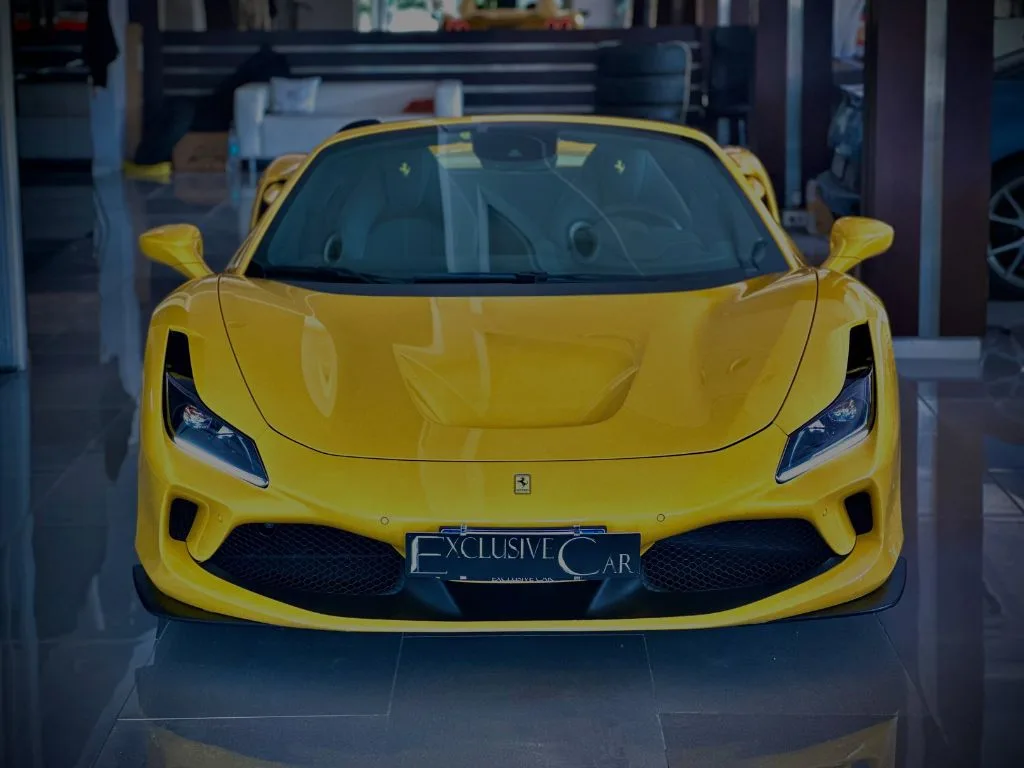 Yellow Ferrari Spider with an Exclusive Car number plate in the showroom