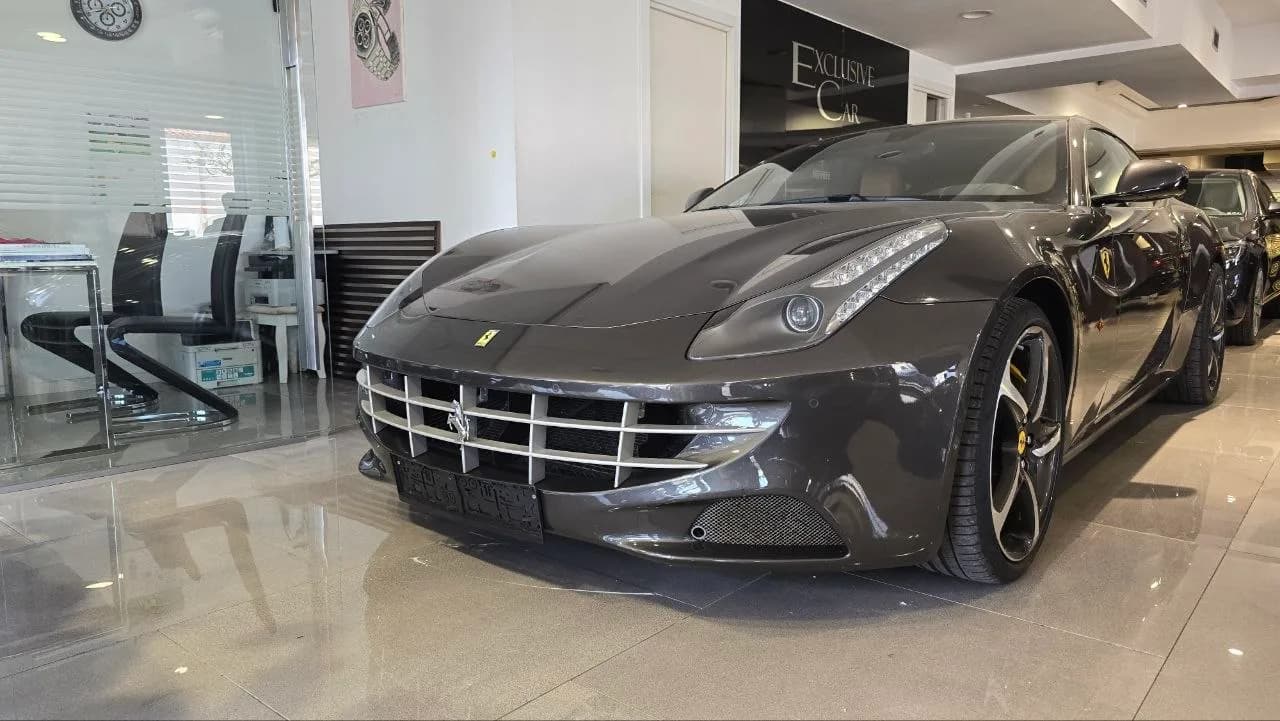Dark grey Ferrari grand tourer in the Exclusive Car showroom