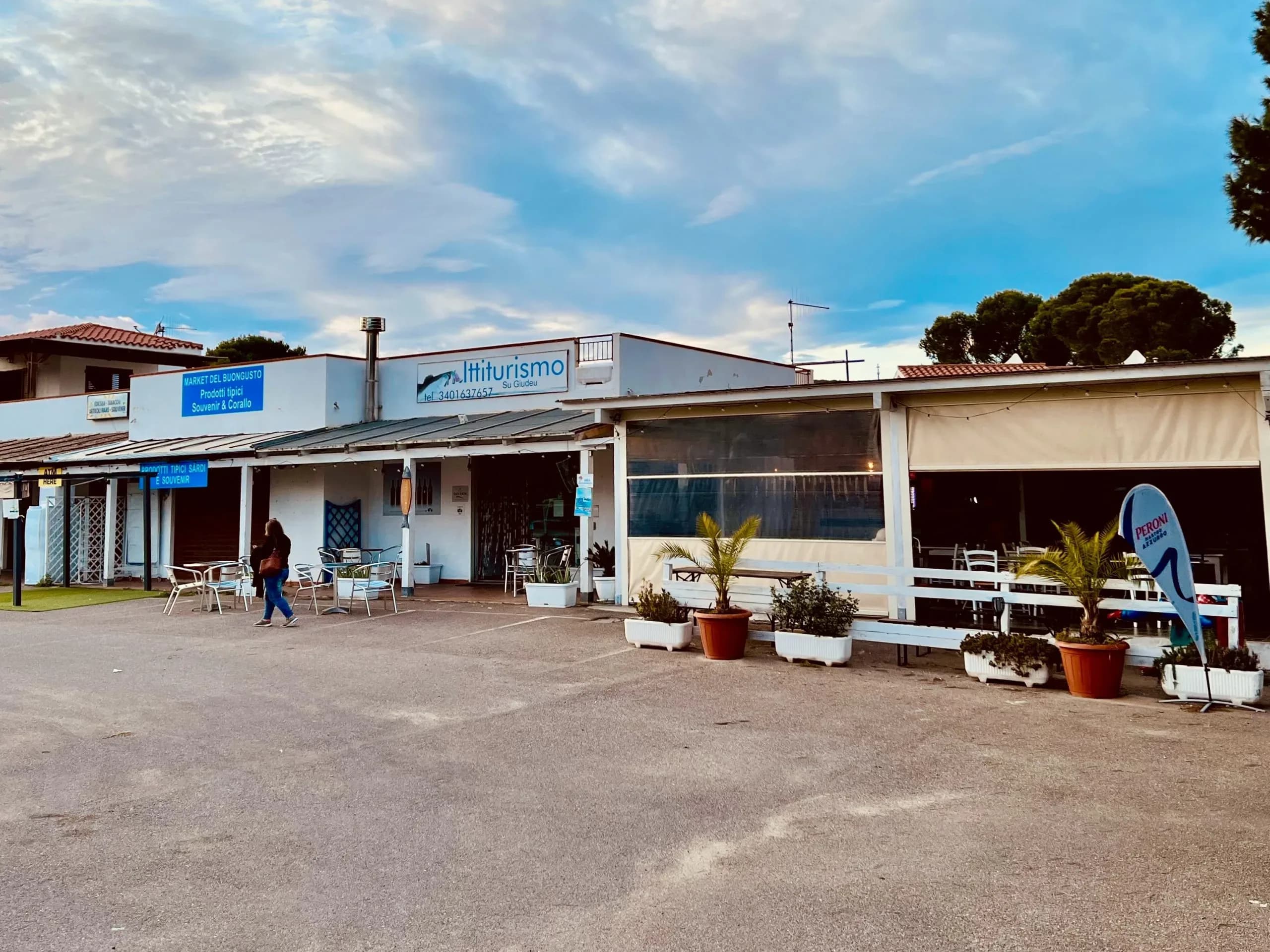 Exterior of 'Ittiturismo Su Giudeu' on a cloudy day.