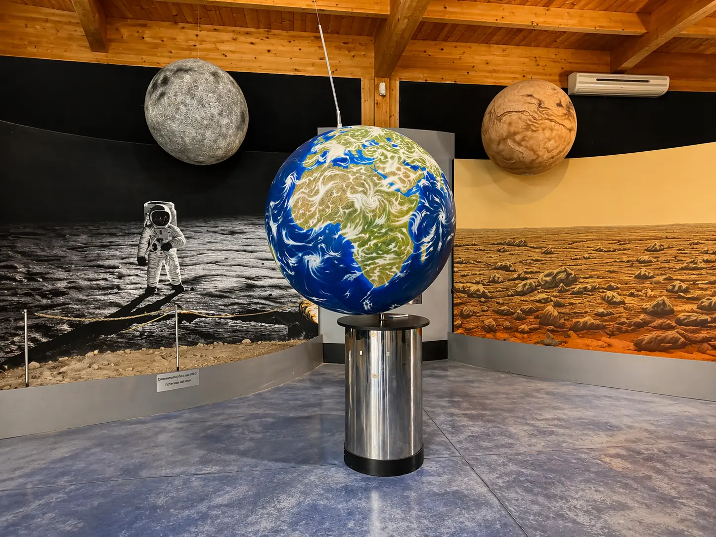 Planetary exhibit featuring Earth, Moon, and Mars.