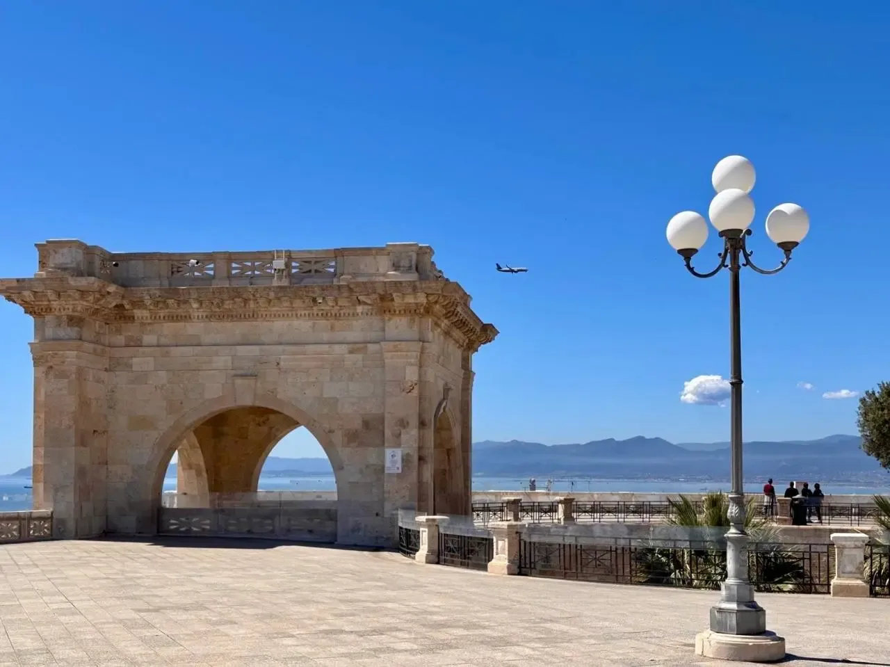 Cagliari, Sardinia viewpoint with monument, sea, mountains, and plane
