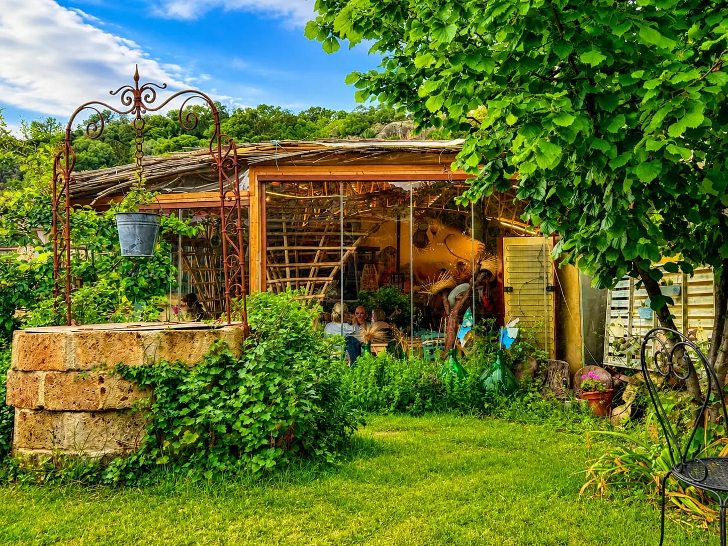 Rustic garden studio surrounded by lush greenery