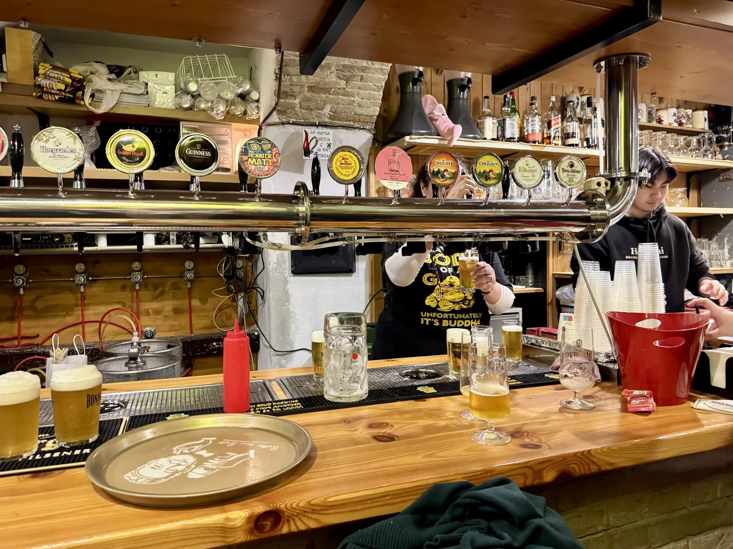 Bartender pouring draft beer at cozy taproom bar